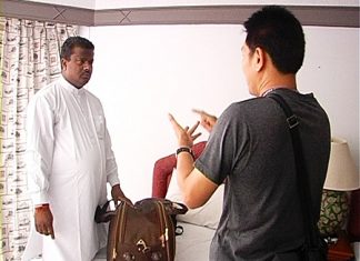 One of the Indian victims, left, talks to authorities about his lost possessions.